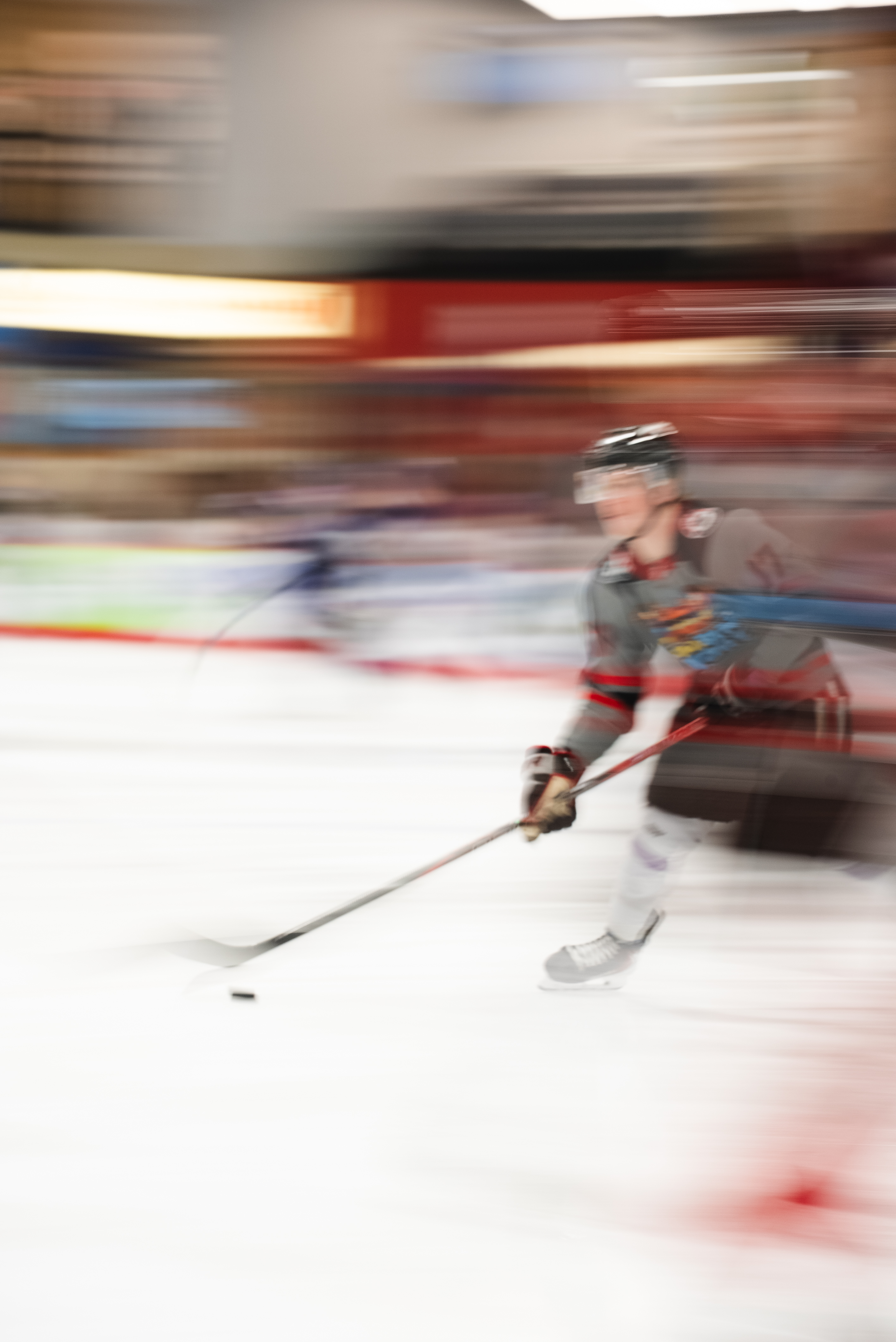 Motion-blur pan of a hockey player with the puck